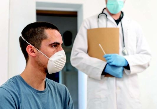 patient sitting in front of a doctor